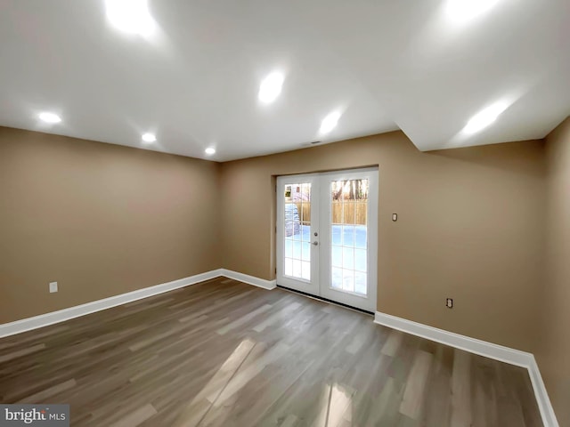 spare room featuring hardwood / wood-style flooring and french doors