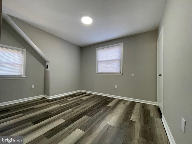 unfurnished room with dark hardwood / wood-style floors and a healthy amount of sunlight