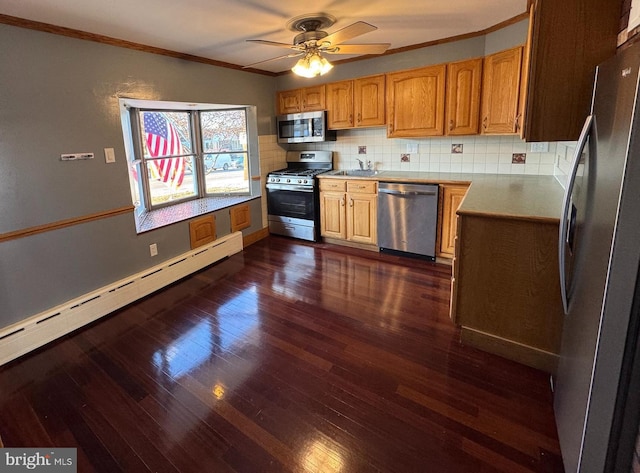 kitchen with backsplash, stainless steel appliances, baseboard heating, and ornamental molding