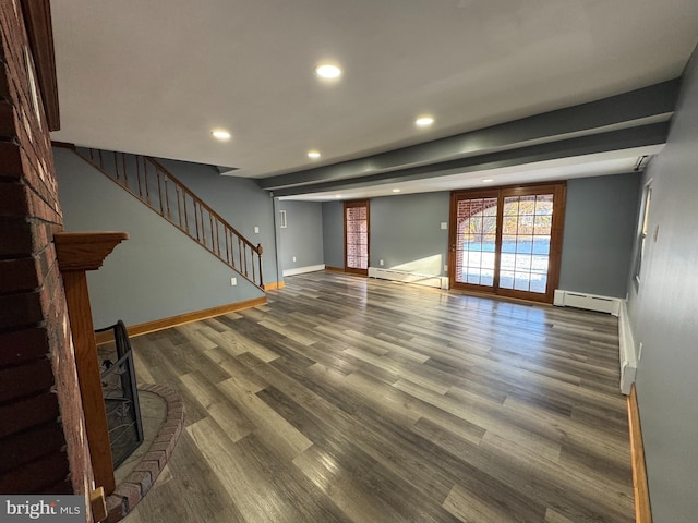 unfurnished living room with dark hardwood / wood-style floors and a baseboard radiator