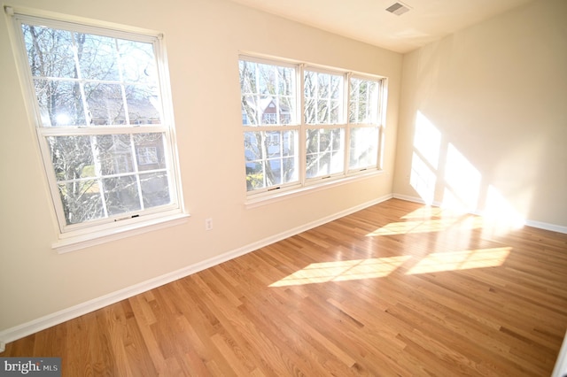 spare room with light hardwood / wood-style flooring