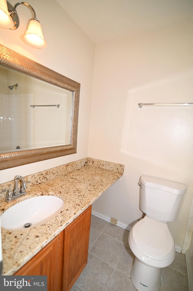 bathroom featuring tile patterned floors, vanity, and toilet