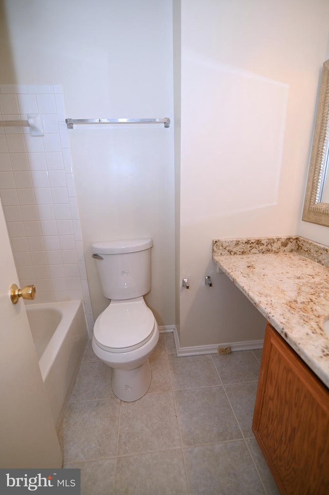 bathroom with tile patterned flooring, vanity, and toilet