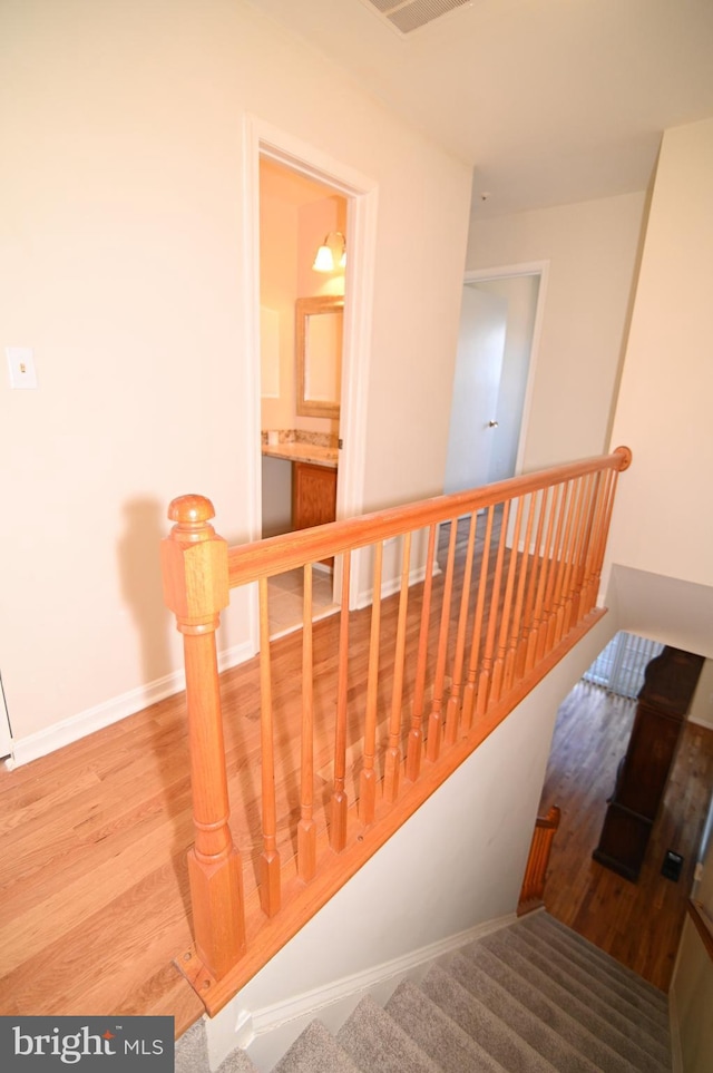 stairs with hardwood / wood-style flooring