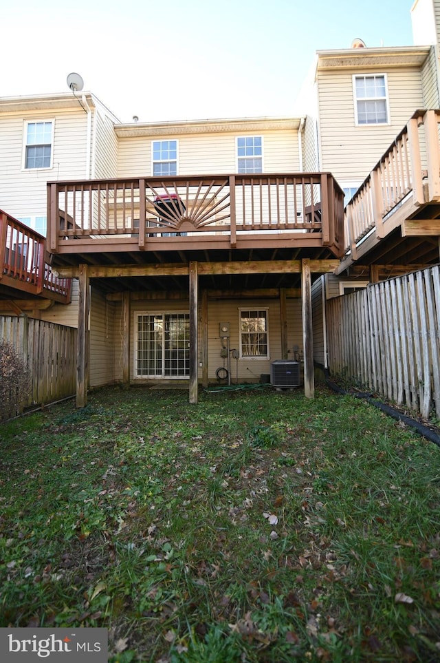 back of house featuring a yard, central AC unit, and a deck