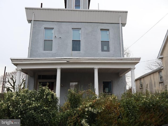 rear view of property with a porch