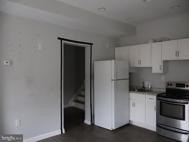 kitchen featuring electric stove, sink, dark hardwood / wood-style floors, white fridge, and white cabinetry