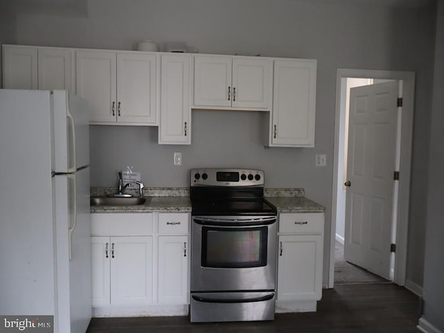 kitchen with stainless steel range with electric stovetop, white fridge, white cabinets, and sink