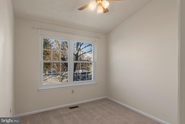 carpeted spare room with lofted ceiling and ceiling fan