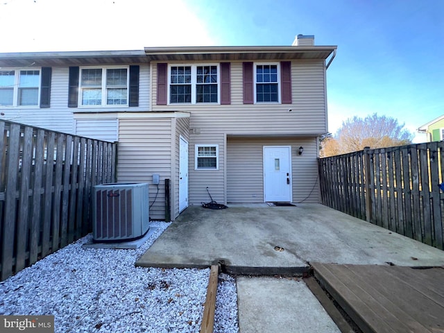 rear view of property featuring a patio and central AC unit