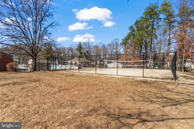 view of home's community featuring fence and volleyball court