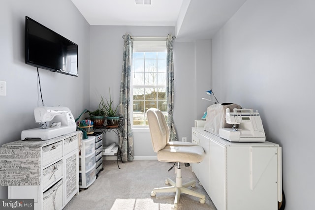 home office with a wealth of natural light, light colored carpet, and washer / dryer