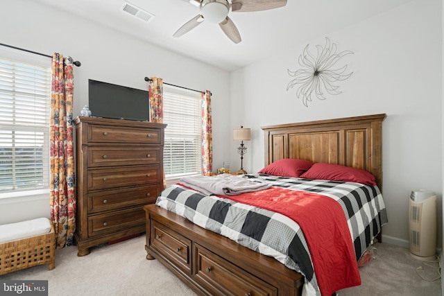 carpeted bedroom with multiple windows and ceiling fan