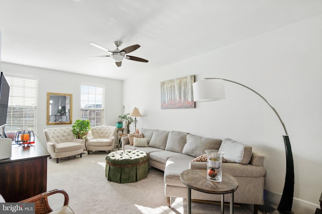 carpeted living room featuring ceiling fan