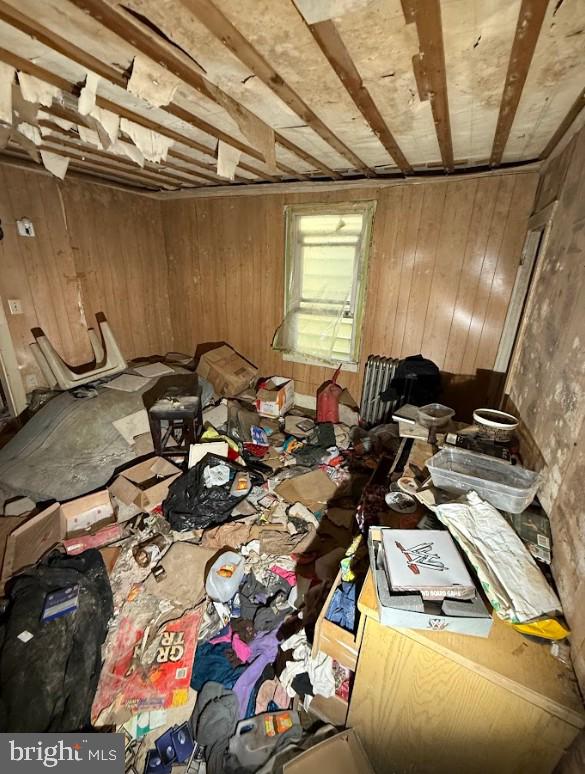 miscellaneous room with wood walls