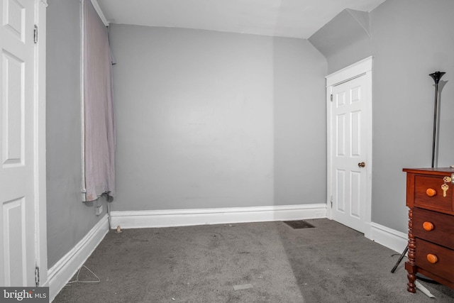 unfurnished bedroom featuring dark carpet