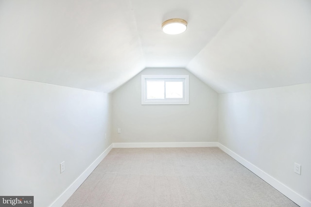 bonus room featuring light colored carpet and lofted ceiling