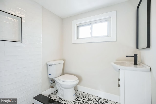 bathroom featuring tile patterned flooring, vanity, and toilet