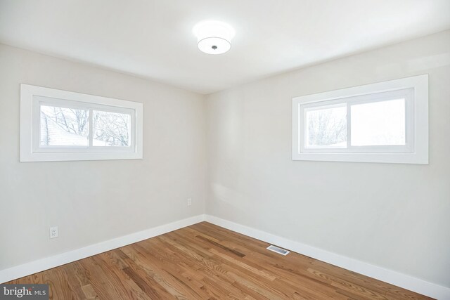 empty room featuring hardwood / wood-style floors and a healthy amount of sunlight