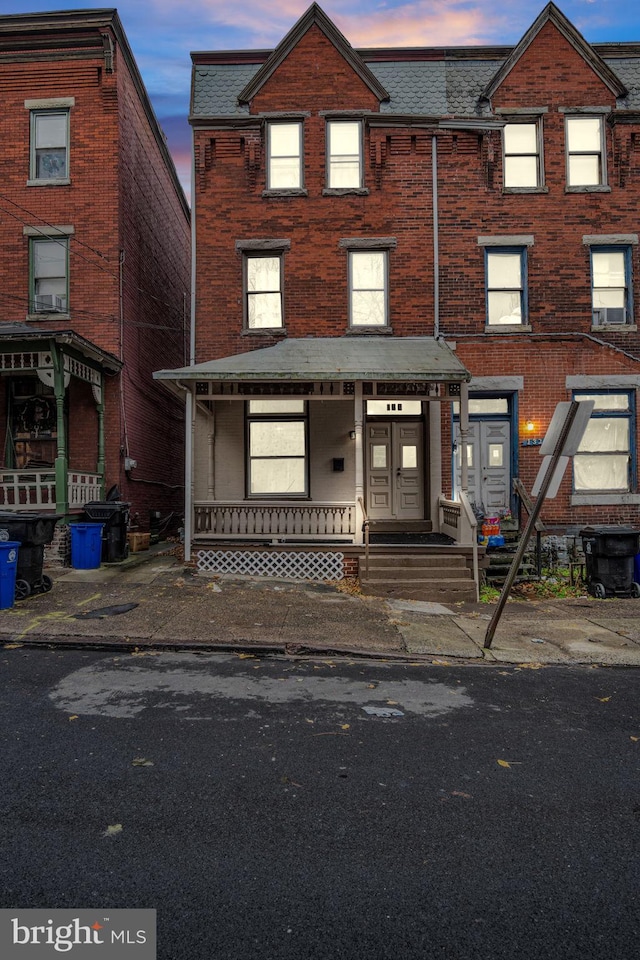 townhome / multi-family property featuring a porch