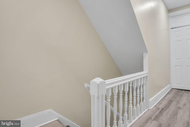 stairs featuring hardwood / wood-style floors