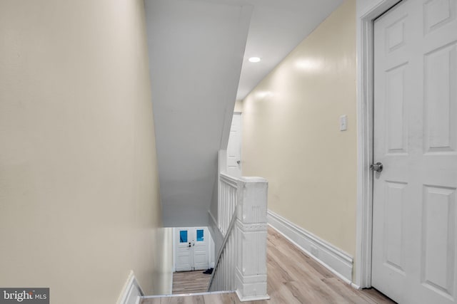 staircase with hardwood / wood-style floors