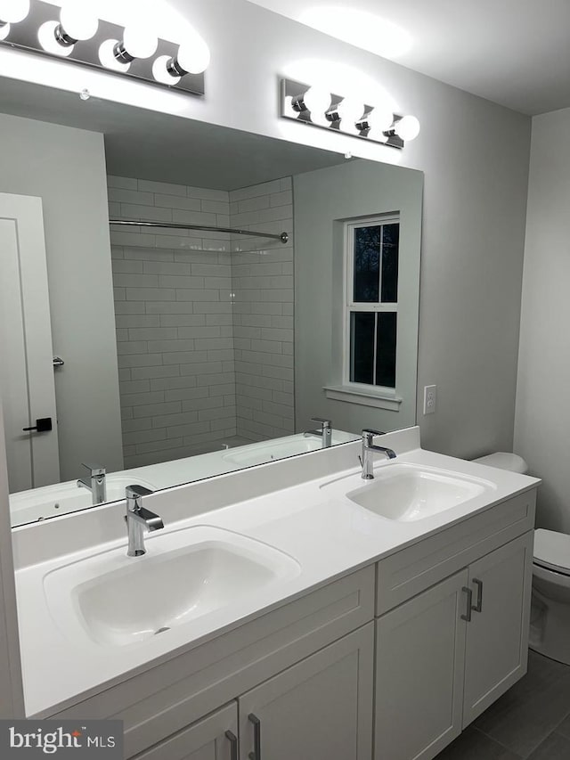 bathroom featuring vanity and toilet