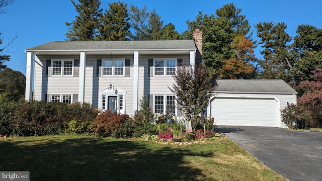 view of front of house with a front yard and a garage