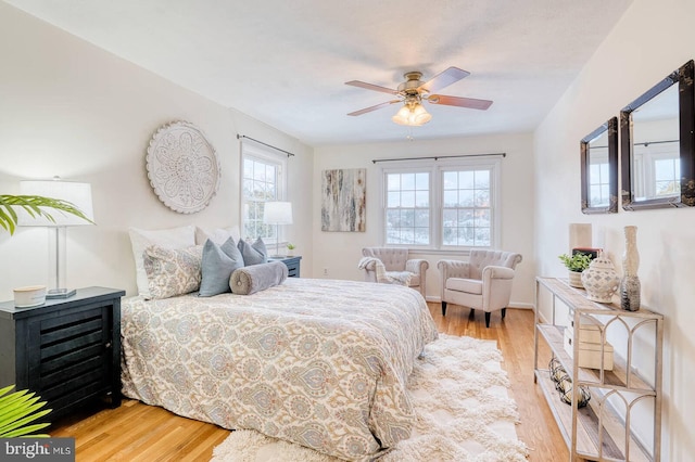 bedroom with ceiling fan and light hardwood / wood-style floors