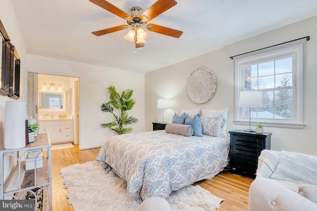 bedroom featuring connected bathroom, ceiling fan, and light hardwood / wood-style flooring