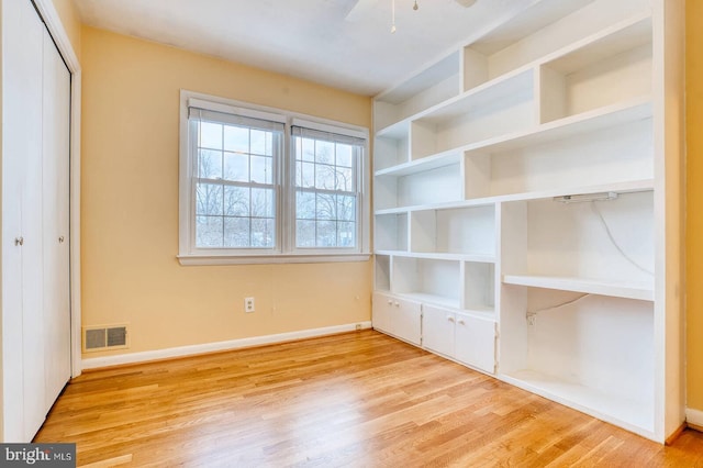 unfurnished bedroom featuring a closet, ceiling fan, and light hardwood / wood-style flooring