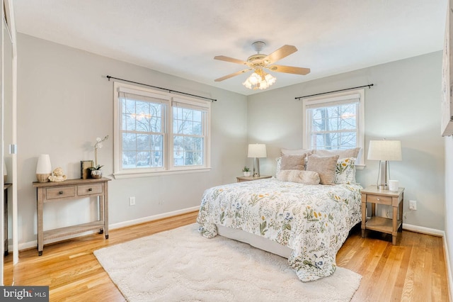 bedroom with wood-type flooring and ceiling fan