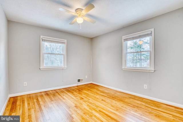 empty room with hardwood / wood-style flooring and ceiling fan