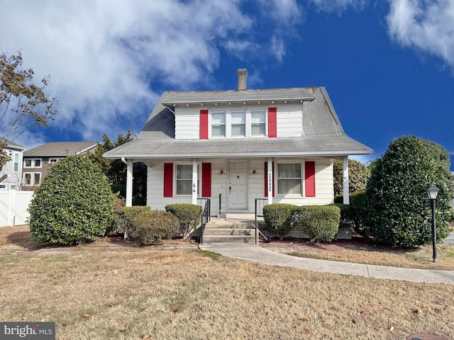 view of front of home with a porch and a front lawn