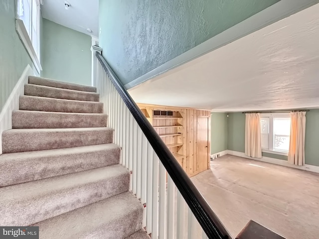 stairway with concrete flooring