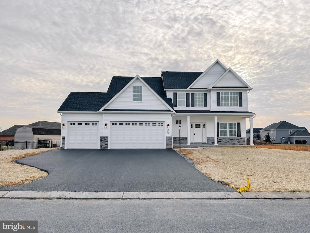 view of front of property featuring covered porch and a garage