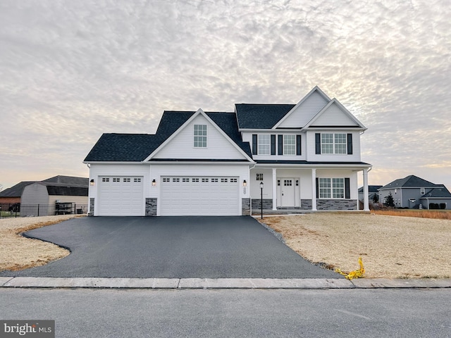 view of front of property featuring covered porch and a garage