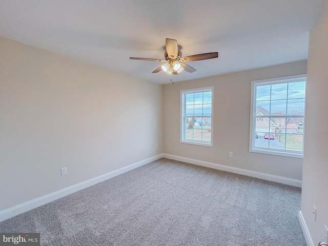 unfurnished room with carpet flooring and ceiling fan