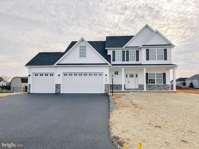 view of front of property with a garage and covered porch