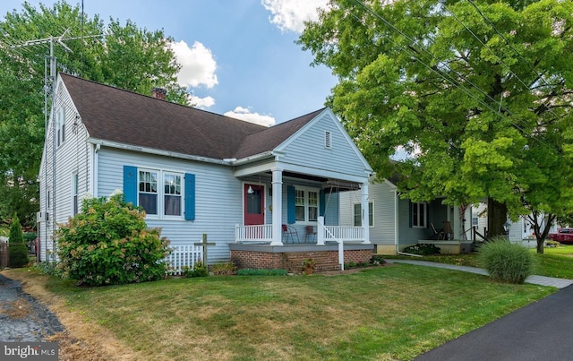 view of front of home with covered porch and a front yard