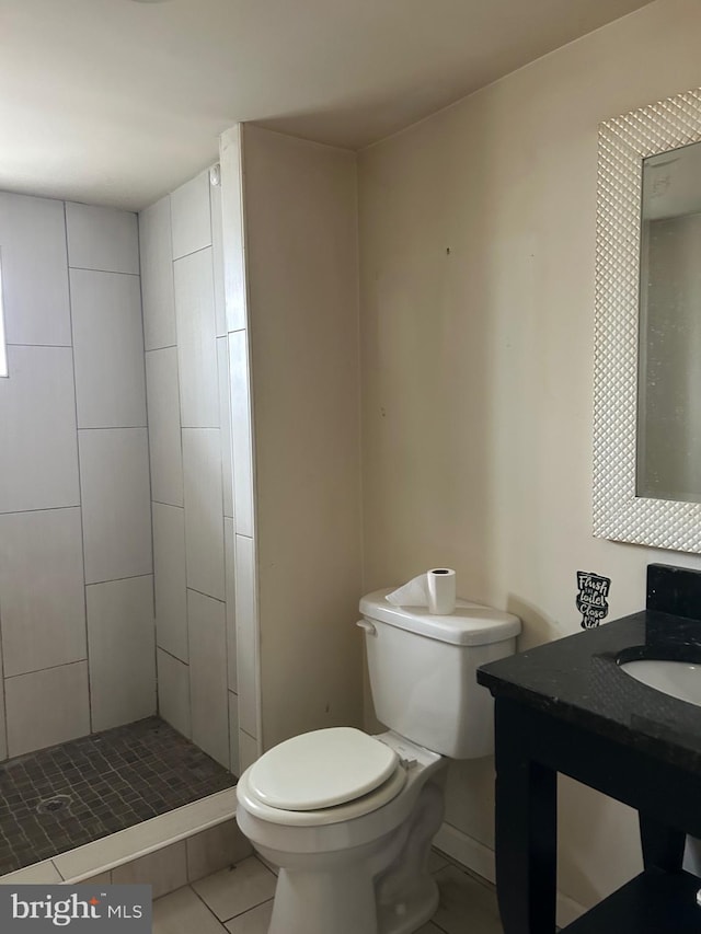 full bathroom with a stall shower, vanity, toilet, and tile patterned floors