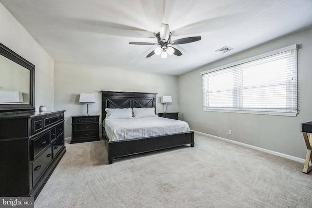 bedroom with ceiling fan and light carpet