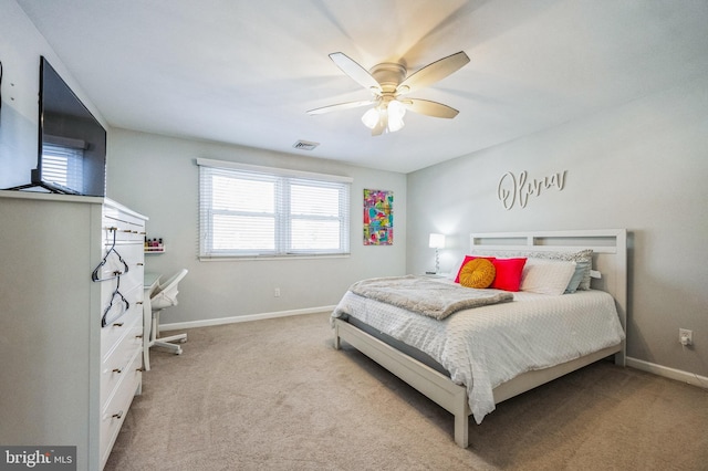 carpeted bedroom with ceiling fan and multiple windows