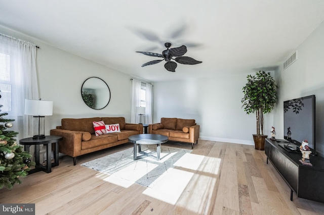 living room with ceiling fan and light hardwood / wood-style floors