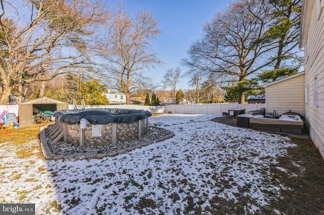 snowy yard featuring a covered pool