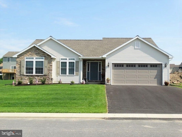 view of front of home with a front yard and a garage