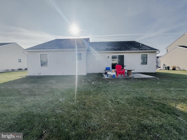 rear view of house featuring a lawn and a patio area