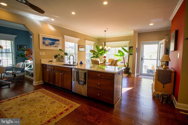 kitchen featuring pendant lighting, dishwasher, sink, dark hardwood / wood-style flooring, and kitchen peninsula