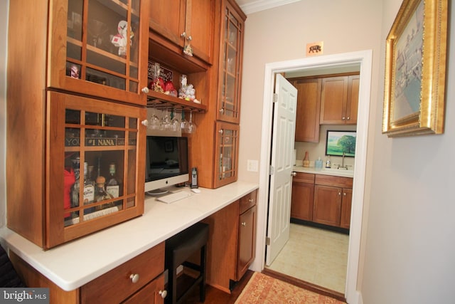 bar featuring sink and ornamental molding