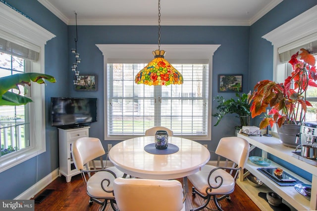 dining space featuring crown molding and dark wood-type flooring